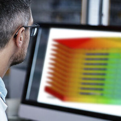 Man sitting at a computer running a simulation